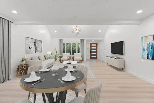 a living room with furniture a flat screen tv and a large window