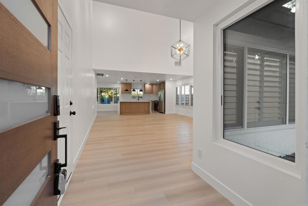 1708 Harold Road Escondido, CA 92026 - Photo 6 of 40 a view of a hallway with a white walls and wooden floor