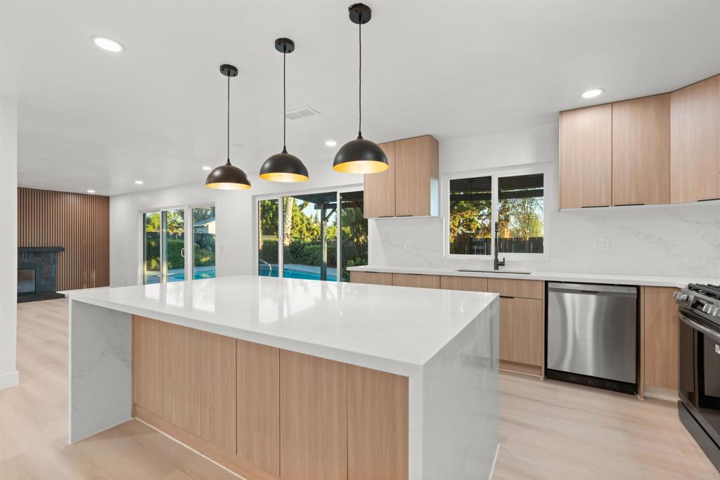 1708 Harold Road Escondido, CA 92026 - Photo 8 of 40 a view of a kitchen with kitchen island a large window a sink and a large window