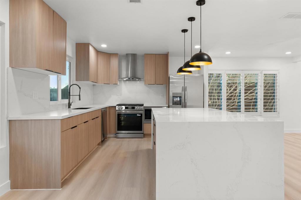 1708 Harold Road Escondido, CA 92026 - Photo 10 of 40 a kitchen with stainless steel appliances a sink stove and cabinets
