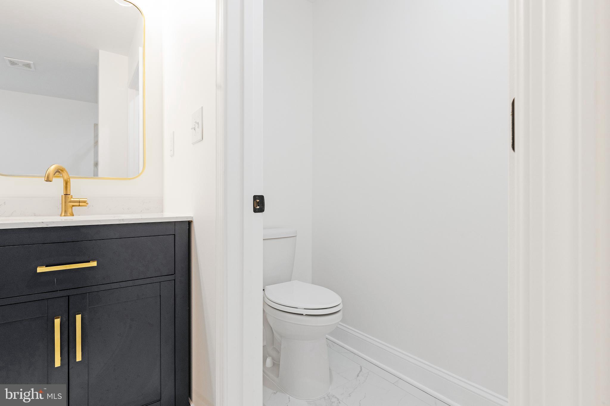 1102 Harlem Avenue Baltimore, MD 21217 - Photo 19 of 36 a bathroom with a toilet and a sink