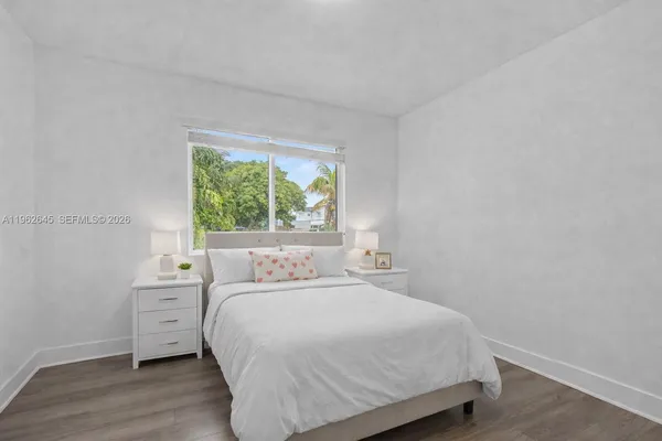 a bedroom with a large bed and a window
