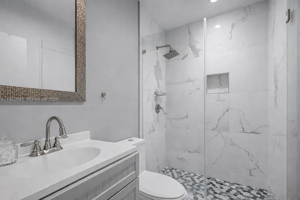 a bathroom with a sink toilet and shower