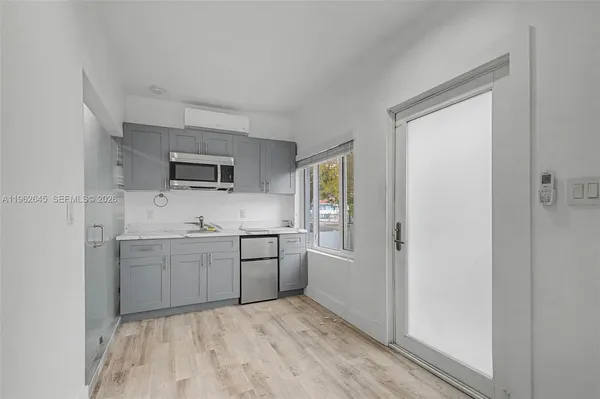 a room with a sink and a stove top oven
