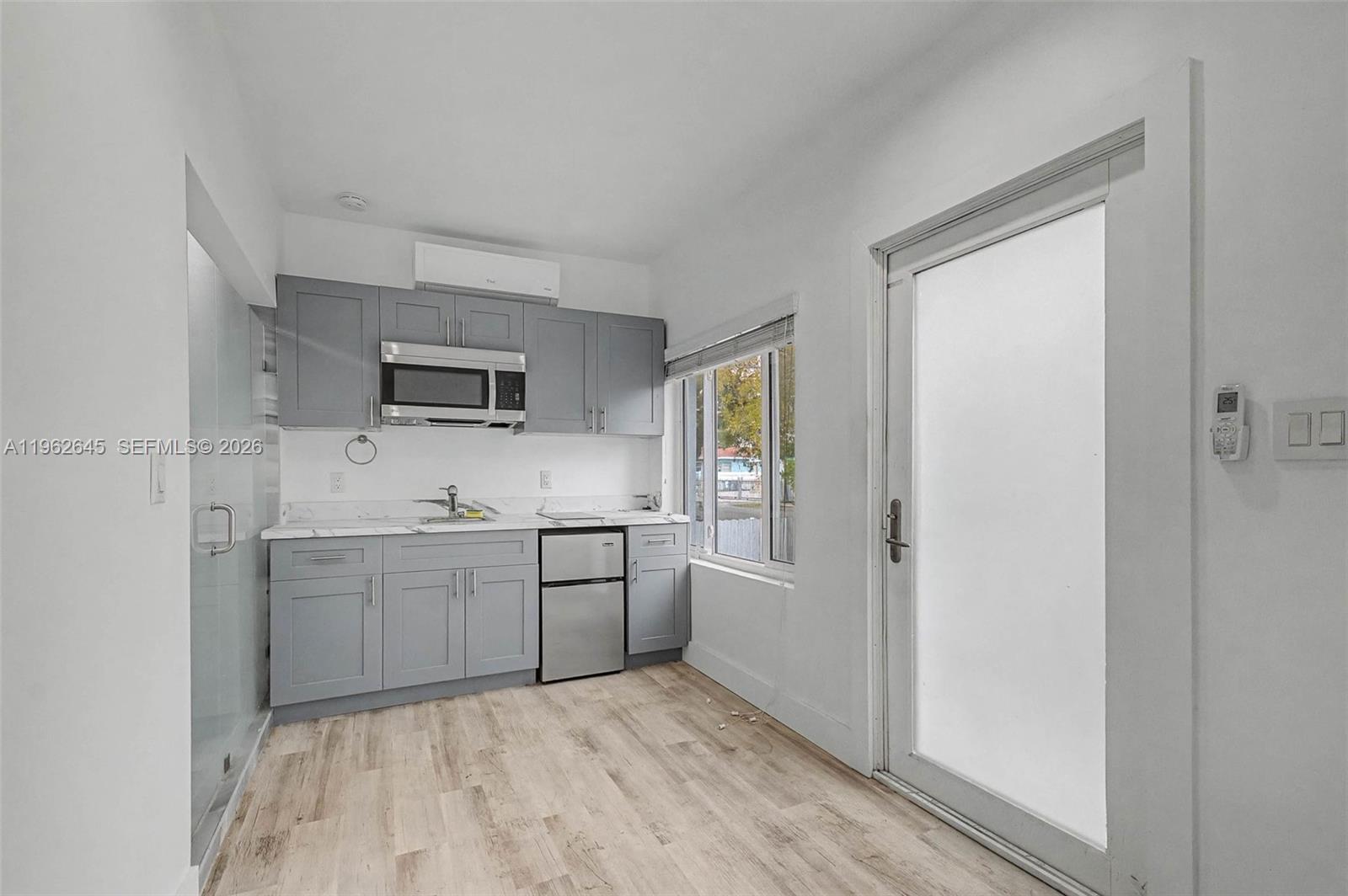 2900 Southwest 4th Street Miami, FL 33135 - Photo 14 of 18 a room with a sink and a stove top oven