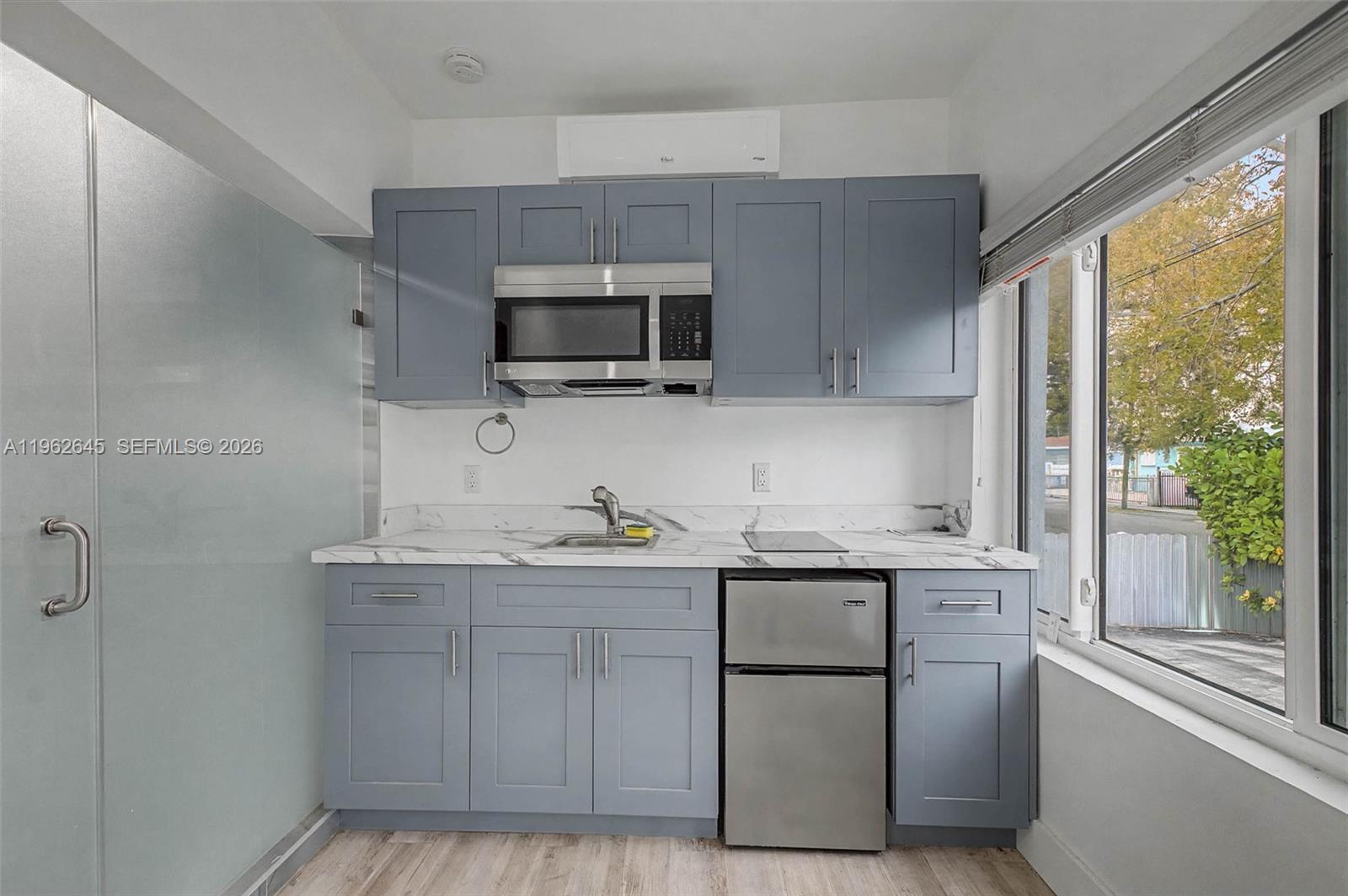 2900 Southwest 4th Street Miami, FL 33135 - Photo 15 of 18 a kitchen with stainless steel appliances granite countertop a stove a sink and a microwave