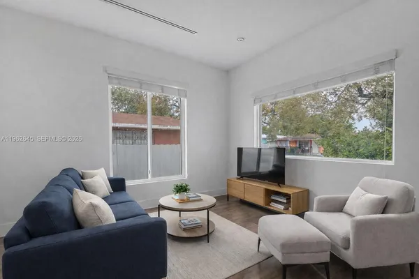 a living room with furniture and a large window