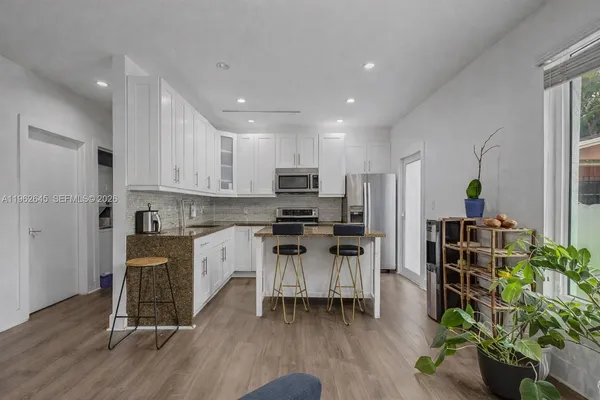 a kitchen with stainless steel appliances a refrigerator and a stove top oven