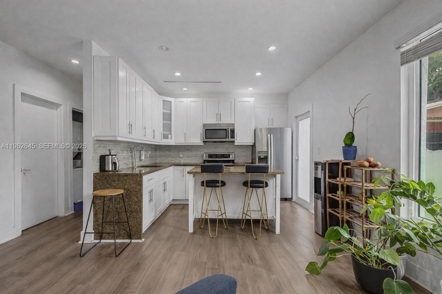 2900 Southwest 4th Street Miami, FL 33135 - Photo 7 of 18 a kitchen with stainless steel appliances a refrigerator and a stove top oven