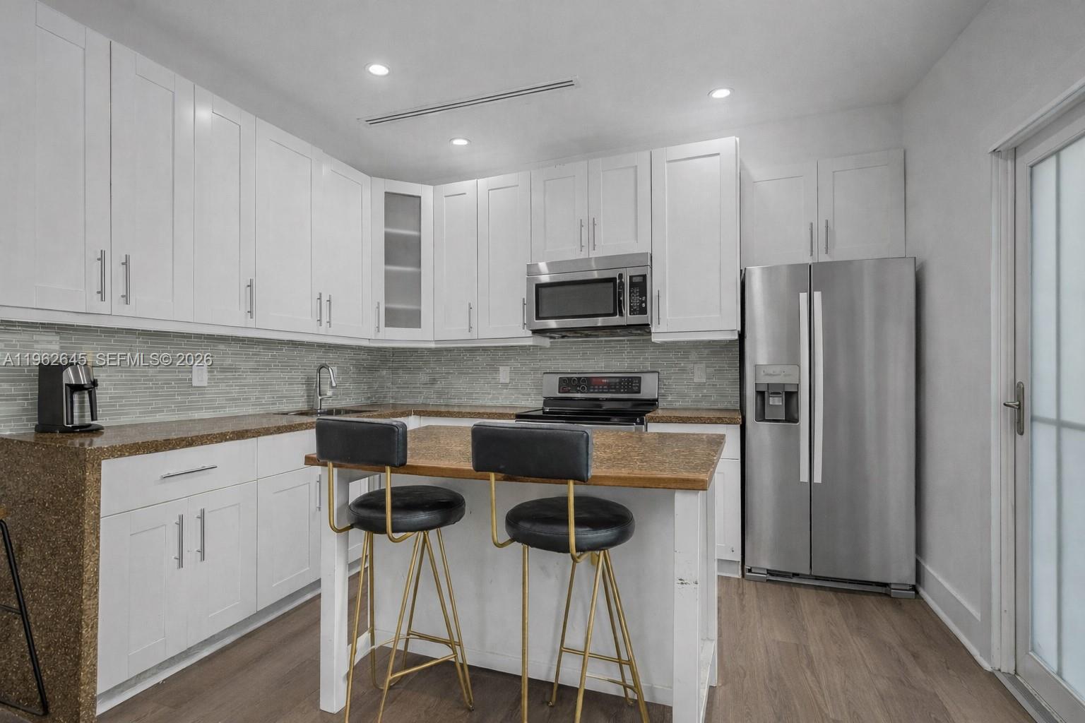 2900 Southwest 4th Street Miami, FL 33135 - Photo 8 of 18 a kitchen with stainless steel appliances granite countertop a refrigerator and a stove top oven