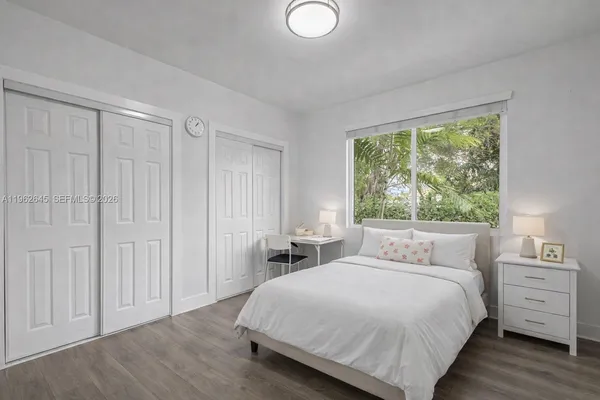a bedroom with a large bed and a window
