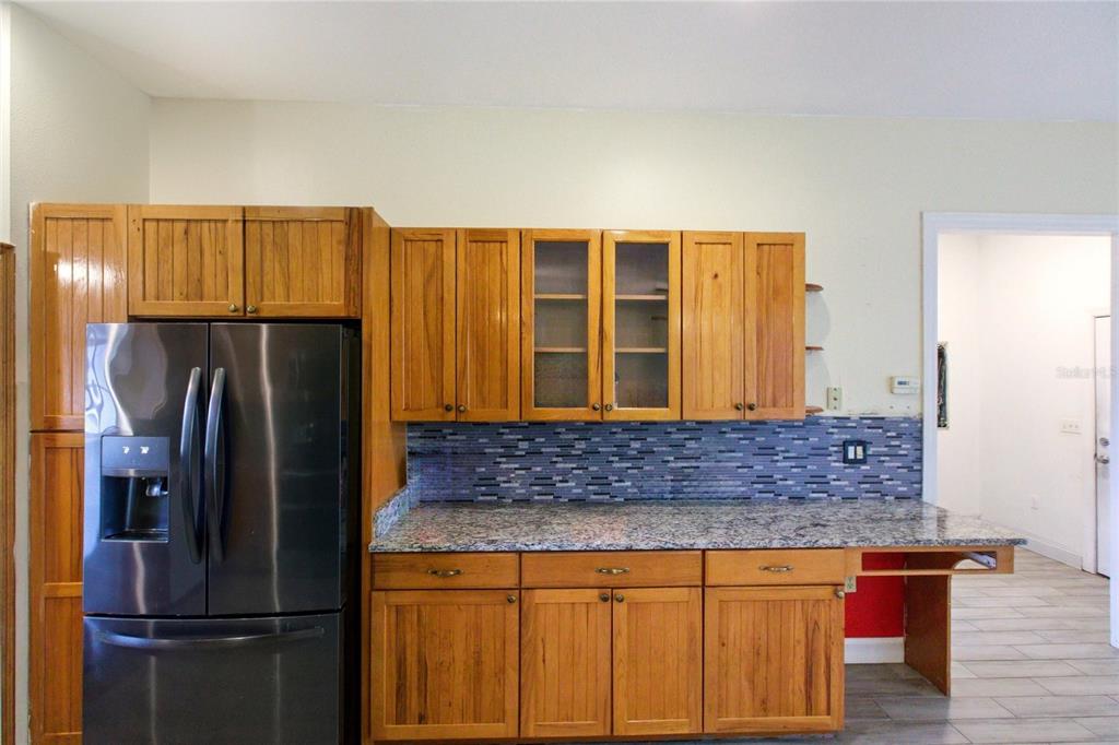 1841 State Rte 66 Zolfo Springs, FL 33890 - Photo 12 of 34 a kitchen with stainless steel appliances granite countertop a refrigerator and a sink