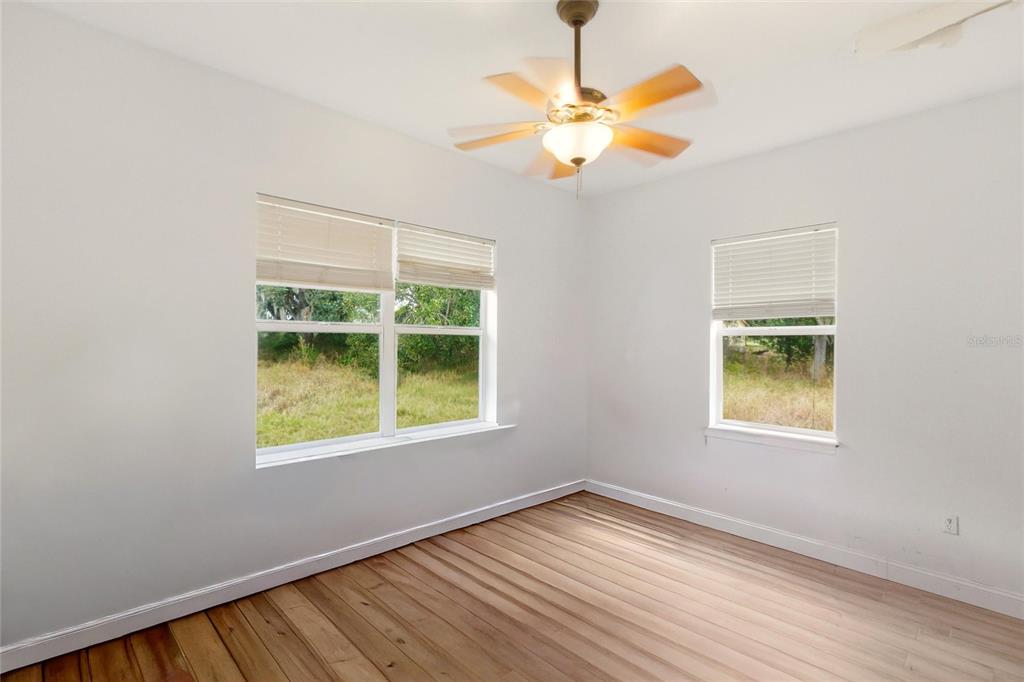 1841 State Rte 66 Zolfo Springs, FL 33890 - Photo 22 of 34 a view of an empty room with wooden floor and a window