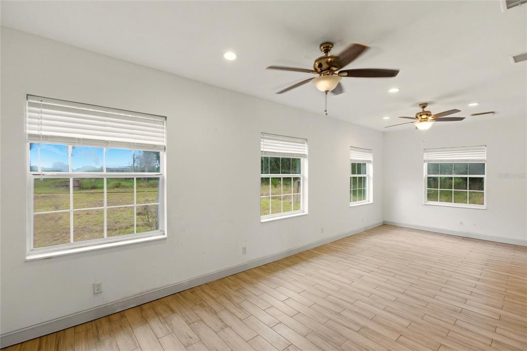 1841 State Rte 66 Zolfo Springs, FL 33890 - Photo 7 of 34 a view of an empty room with a window and wooden floor