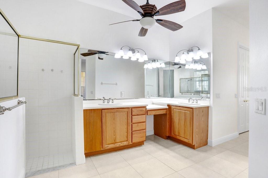 699 Glendora Road Kissimmee, FL 34759 - Photo 13 of 56 a spacious bathroom with a granite countertop sink mirror and bathtub