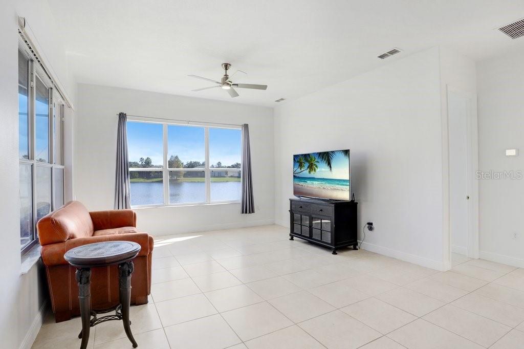 699 Glendora Road Kissimmee, FL 34759 - Photo 23 of 56 a living room with furniture and a flat screen tv