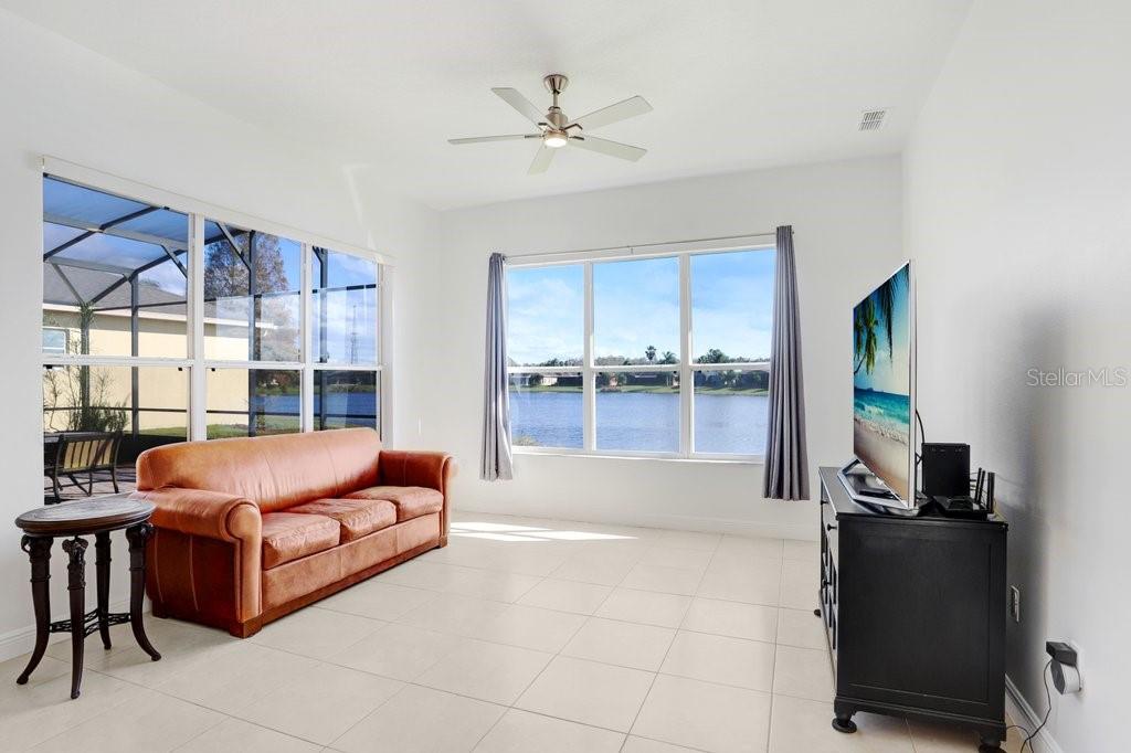 699 Glendora Road Kissimmee, FL 34759 - Photo 25 of 56 a living room with furniture and a fireplace