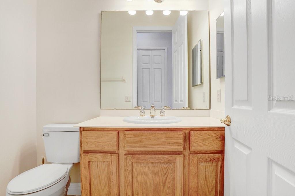 699 Glendora Road Kissimmee, FL 34759 - Photo 29 of 56 a bathroom with a sink a toilet and mirror
