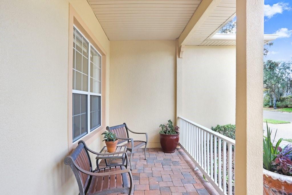 699 Glendora Road Kissimmee, FL 34759 - Photo 4 of 56 a balcony with table and chairs and potted plants