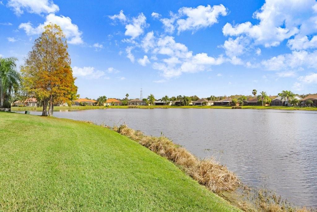 699 Glendora Road Kissimmee, FL 34759 - Photo 45 of 56 a view of a lake with houses in the background