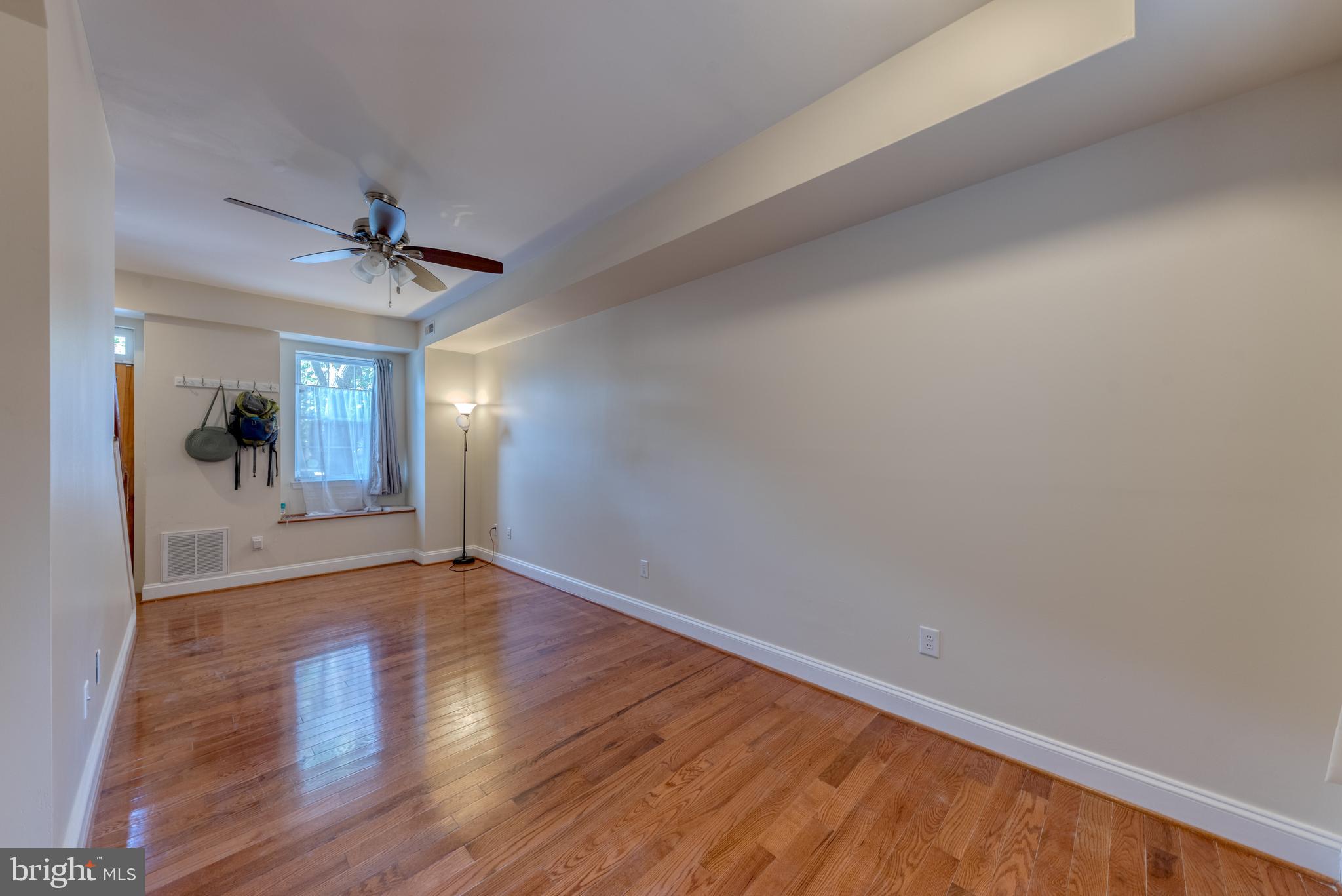 1818 Bank Street Baltimore, MD 21231 - Photo 5 of 20 wooden floor in an empty room with a window