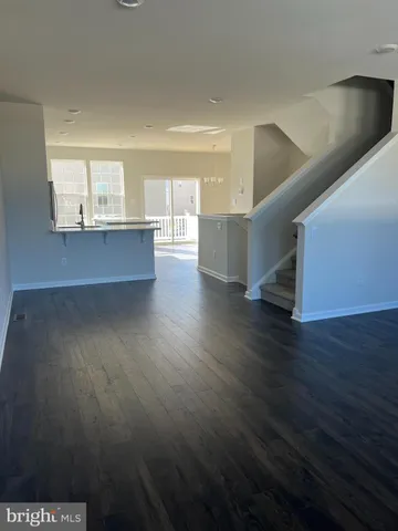 a view of kitchen and hall with wooden floor