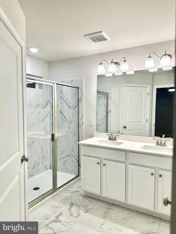 a spacious bathroom with a shower sink mirror and