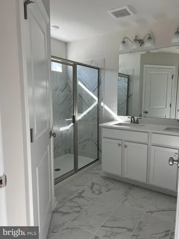 a bathroom with a sink and mirror