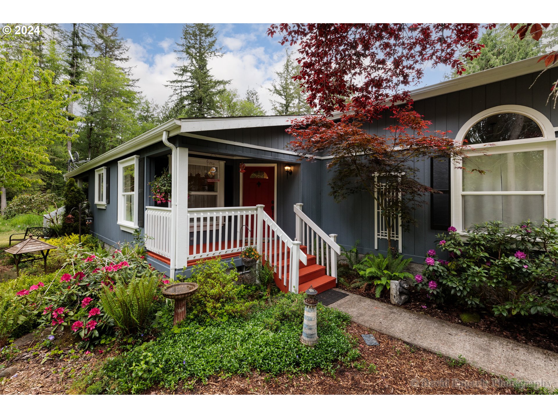 24534 Warren Road Rainier, OR 97048 - Photo 3 of 34 a front view of a house with a yard