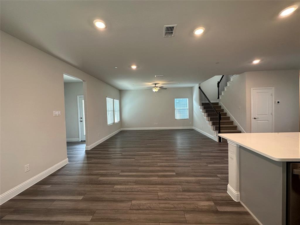 123 Monarch Way Wylie, TX 75098 - Photo 11 of 36 a view of an empty room with wooden floor and stairs