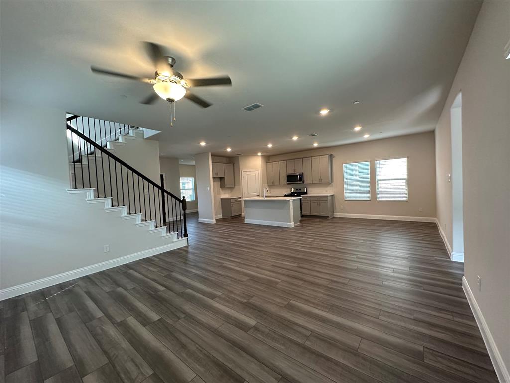 123 Monarch Way Wylie, TX 75098 - Photo 12 of 36 a view of a living room a kitchen with a wooden floor
