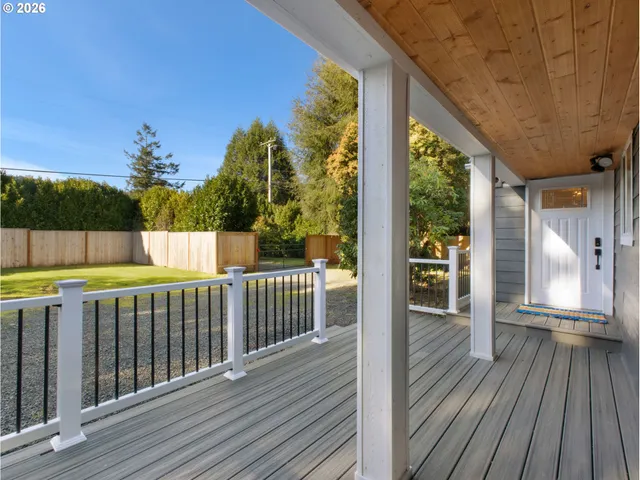 a view of a balcony with wooden floor and fence