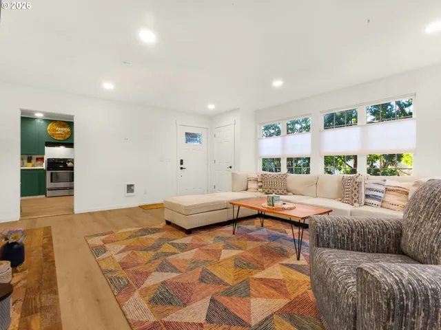 a living room with furniture and painting on the wall