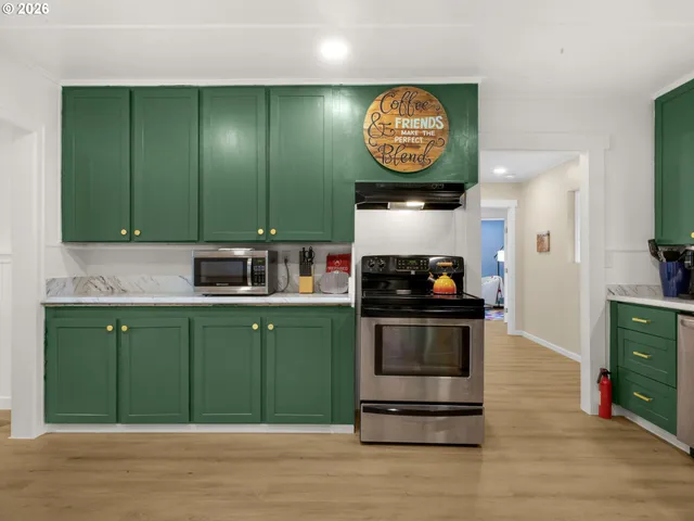 a kitchen with cabinets and a stove top oven