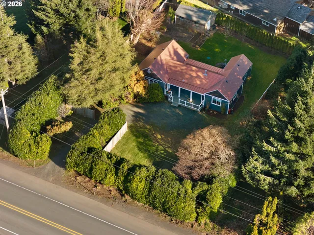 an aerial view of a house with a yard basket ball court and outdoor seating