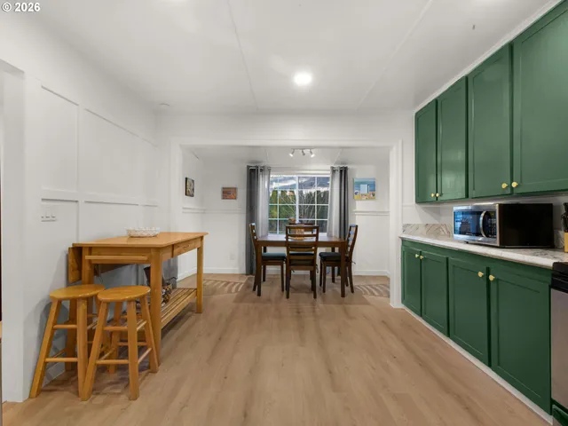 a kitchen with sink cabinets and dining table