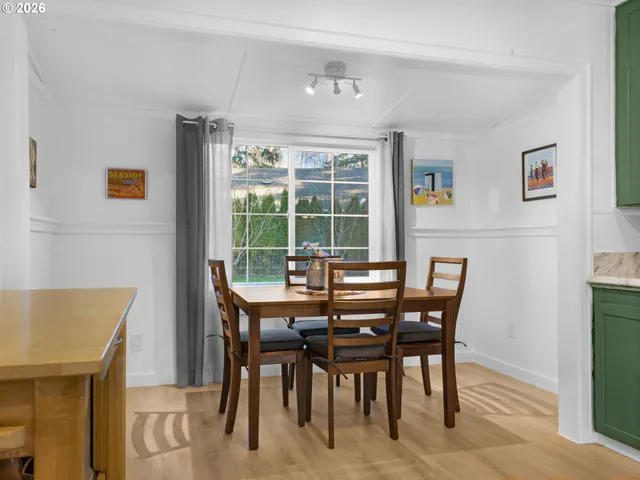 a dining room with furniture and window