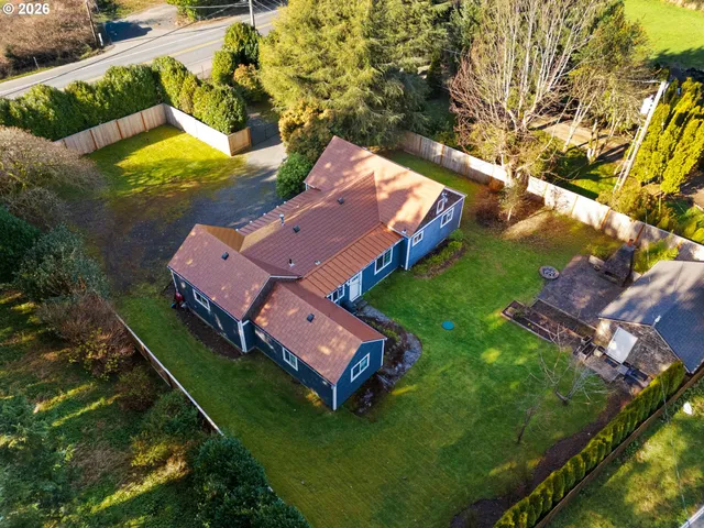 an aerial view of a house with garden space and street view