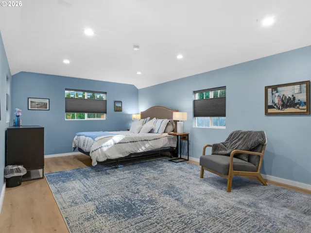 a bedroom with a bed and a couch