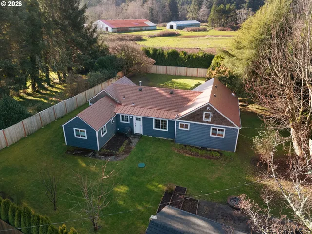 a aerial view of a house with swimming pool garden and patio