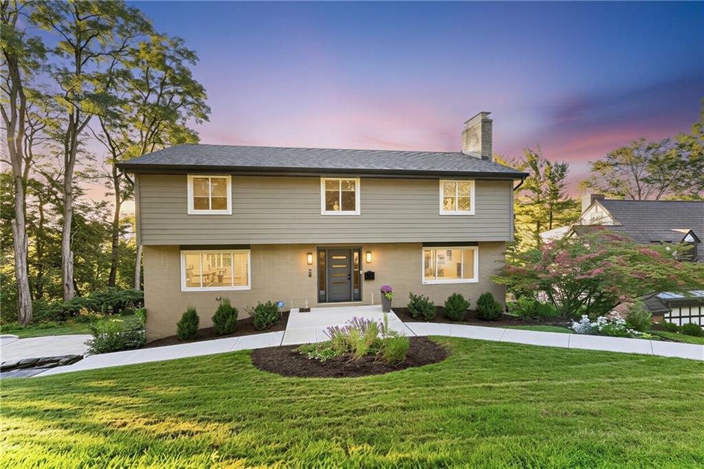 Front of home features inviting fresh landscaping creating a warm welcoming for guests.