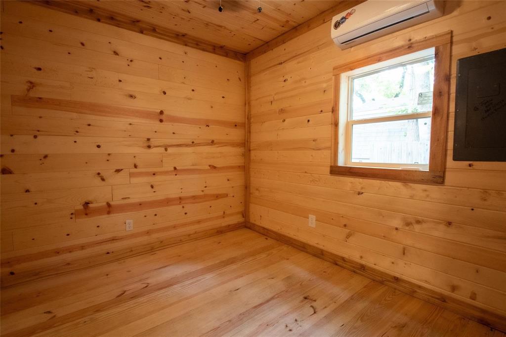 111 Ridgewood Lane Murchison, TX 75778 - Photo 22 of 36 Bedroom 1 with wood walls, trim and flooring