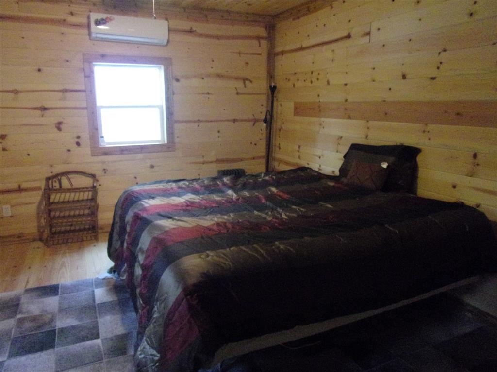 111 Ridgewood Lane Murchison, TX 75778 - Photo 29 of 38 a bedroom with a bed and a window