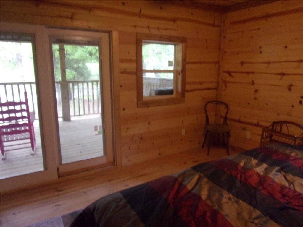 111 Ridgewood Lane Murchison, TX 75778 - Photo 30 of 38 a bedroom with a bed and a window