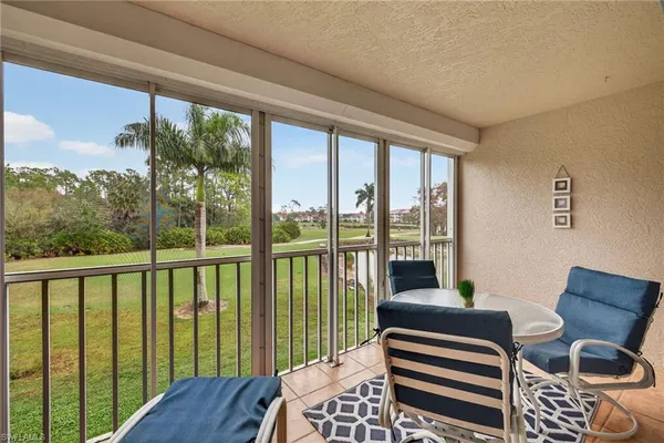 a balcony view with a floor to ceiling window and wooden floor