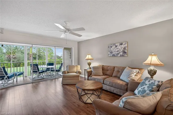 a living room with furniture and a large window with outer view