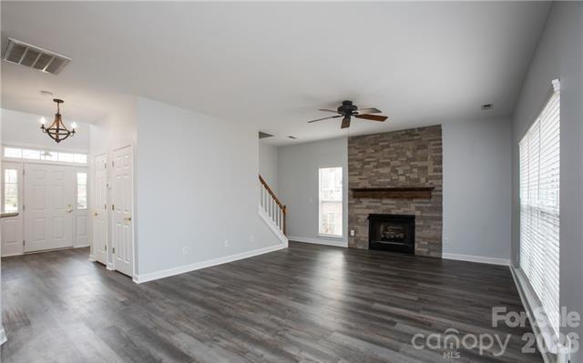815 Knightsbridge Road Fort Mill, SC 29708 - Photo 13 of 30 an empty room with wooden floor fireplace and windows