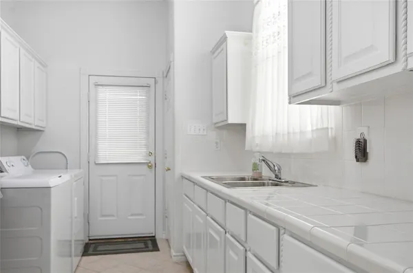 an empty room with windows closet and chandelier fan