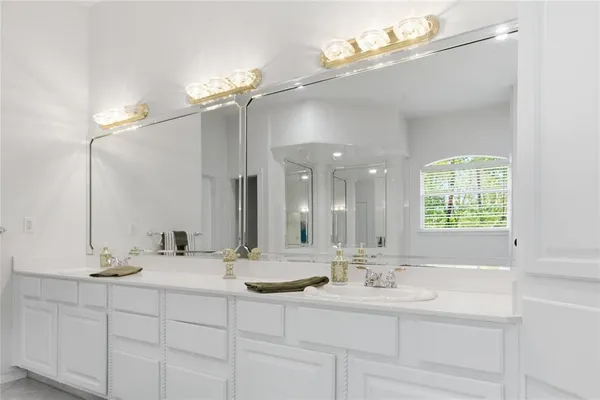 a spacious bedroom with a bed and a potted plant