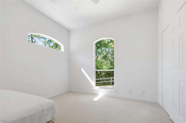 a bedroom with bed and a potted plant